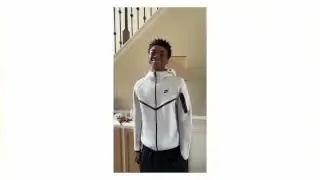 A person wearing a Nike Tech fleece jacket and pants