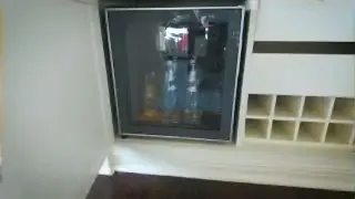 The mini-bar in a hotel room, which the speaker refers to as transforming into a "medicine cabinet" during a severe period of withdrawal.
