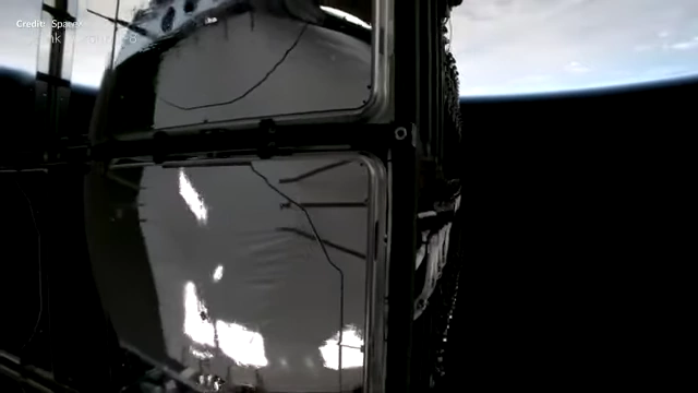 Starlink satellites being deployed from a Falcon 9 fairing in orbit