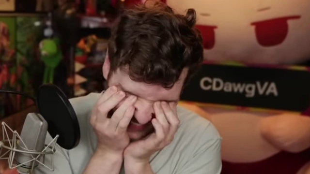 The speaker rubs his eyes in exasperation while talking about the limited time for gaming.