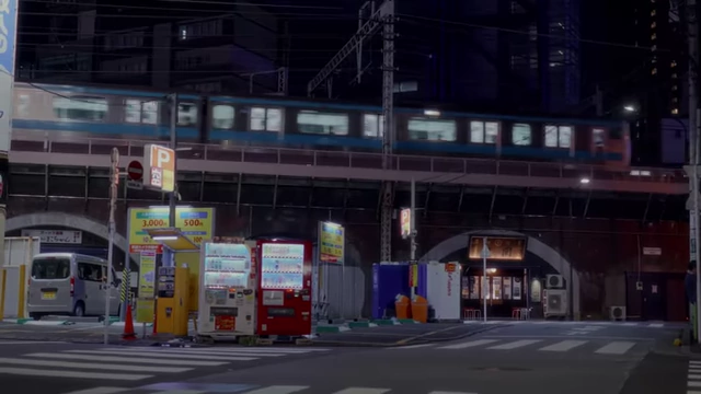 A train passes over an elevated track, with vending machines and street signs below, representing daily infrastructure.