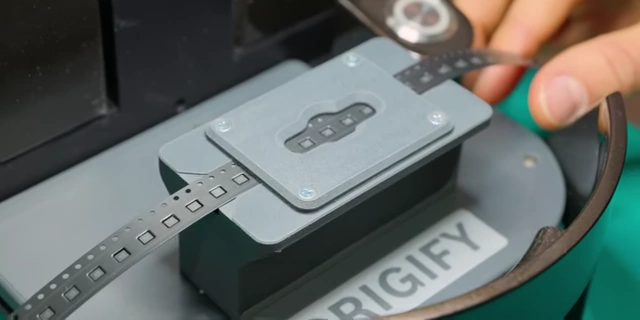 Tiny SMD electronic components being placed into the Origify scanner for authentication.
