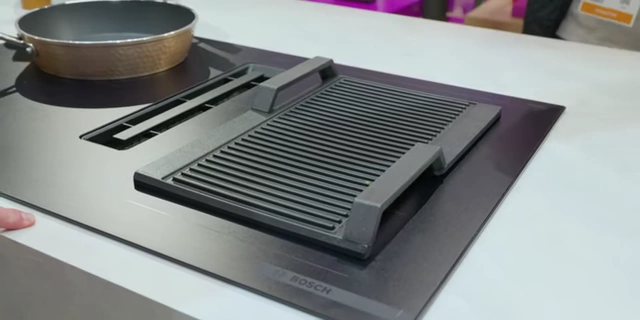 The Bosch induction cooktop featuring a grill accessory, demonstrating the bridging elements.