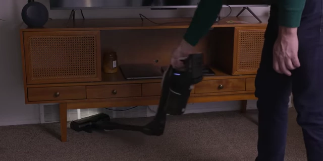 The cordless vacuum utilizing its 90-degree flex tube to clean under furniture.