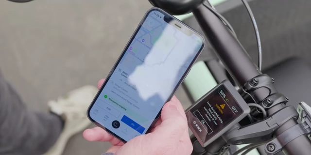 The Bosch eBike Flow app providing turn-by-turn navigation on a smartphone, mounted on an e-bike.