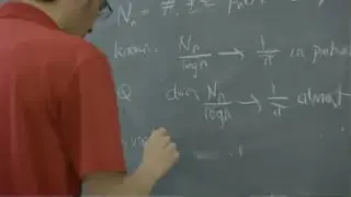 Terry Tao writes mathematical equations on a blackboard, likely related to sequence analysis for signal acquisition algorithms.