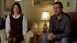 A scene from the movie 'Lars and the Real Girl' with a man sitting next to a lifelike doll.