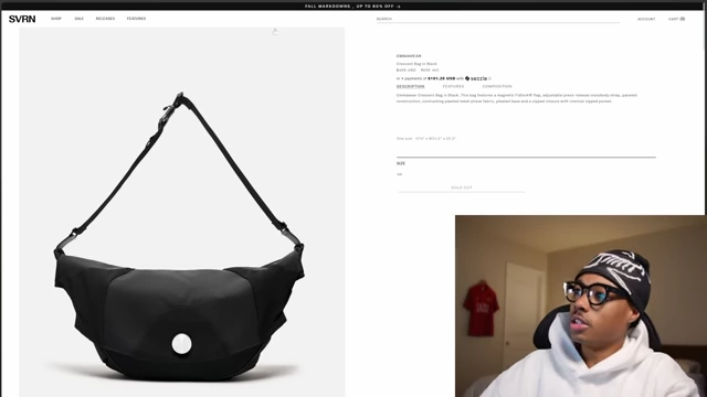A black Common Projects Crescent Bag displayed on a white background
