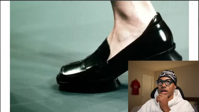 A close-up of a black Prada split-sole loafer on a foot