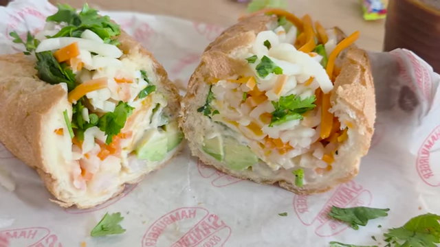 Shrimp and avocado banh mi, cut in half to show the filling