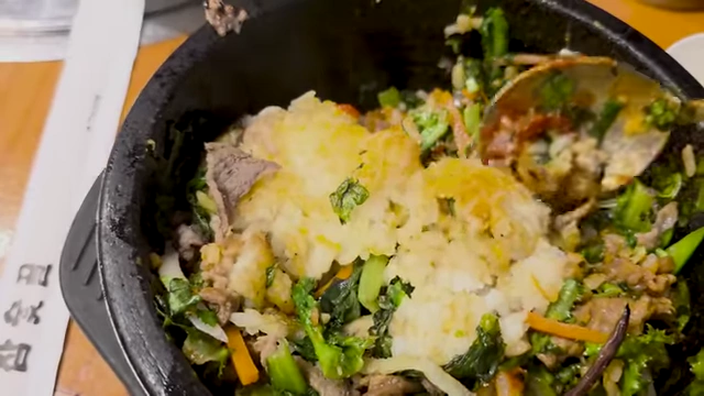Crispy rice forming at the bottom of the stone pot