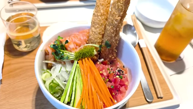 Meepong's signature salmon noodles with tomato, vegetables, and shrimp tempura