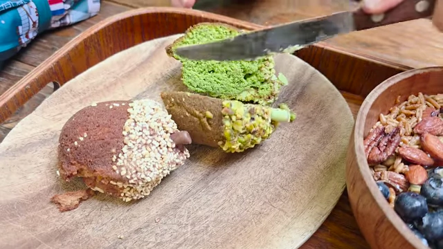 Acorn pastries, one cut to show the matcha pistachio filling
