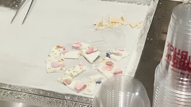 Frozen yogurt pieces with strawberries, nuts, and blueberries