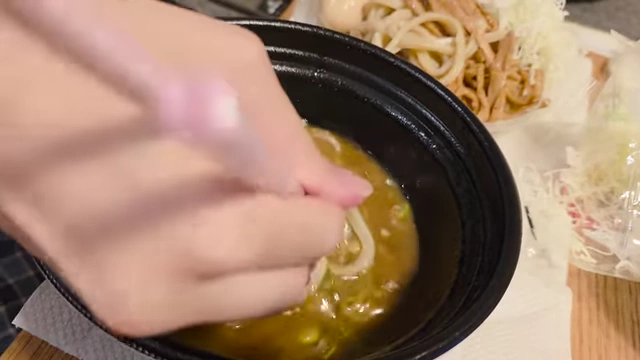 Dipping tsukemen noodles into the thick broth