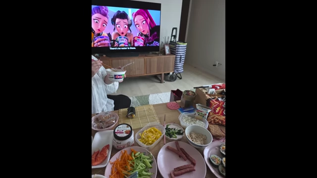 Friends enjoying the kimbap watch party with a spread of food