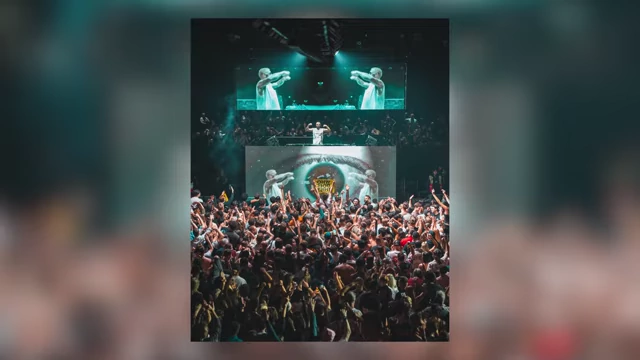 A wide shot of a live music concert crowd
