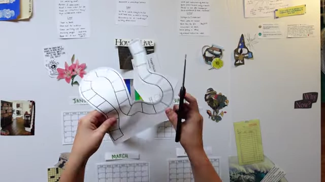 Cutting out a game-board-like path for visually tracking monthly micro-experiments and targets.