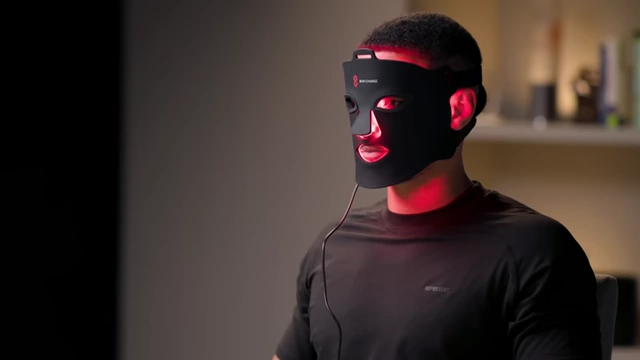 A person wearing a red light therapy mask