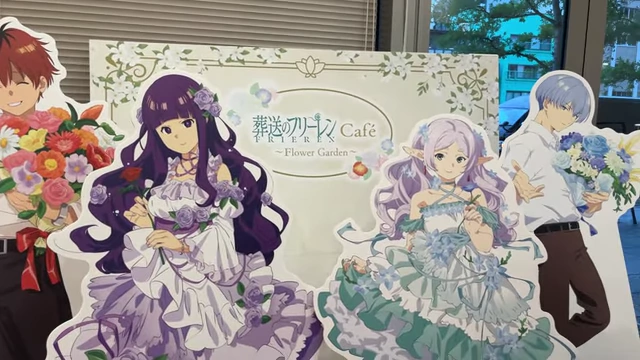 Cardboard standees of Frieren characters in flower-themed formal wear.