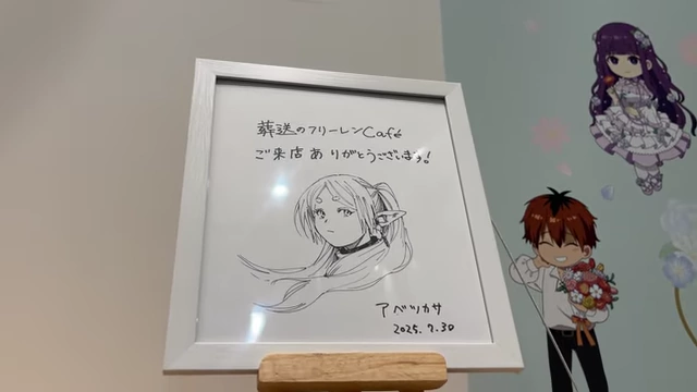 A framed thank you note and doodle of Frieren from mangaka Tugasa Abbe.