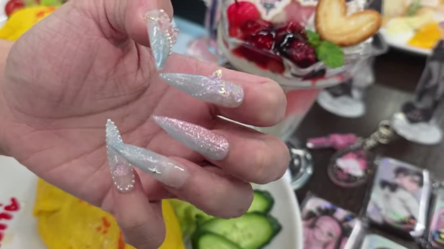 A fan's hand displaying intricate nail art inspired by the Alien Stage character Misu.