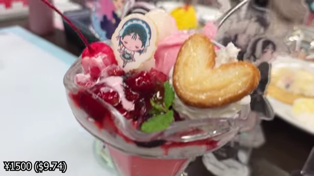 A strawberry yogurt parfait with layers of cream and jelly, topped with mixed berries and a heart-shaped cookie.