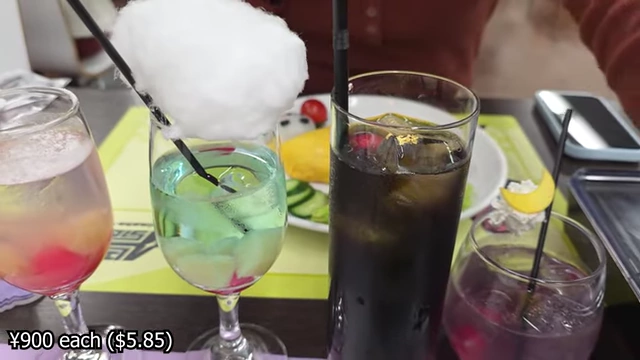 An array of colorful themed drinks with cotton candy and jellies.
