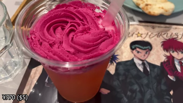 A pink drink topped with a swirl of rose-flavored berry cream.