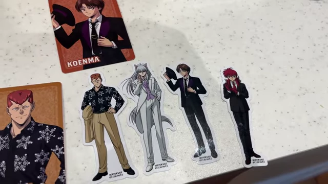 A collection of Yu Yu Hakusho stickers and character cards on a table.