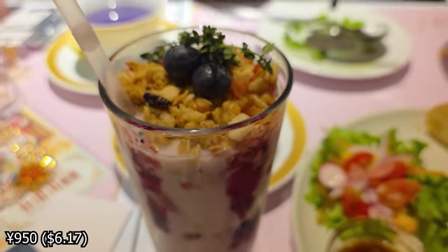 A blueberry yogurt drink topped with crunchy granola and fresh blueberries.