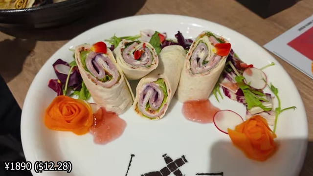 Tortilla wraps with pastrami beef and ham, served with salad and pickled carrot rose petals.