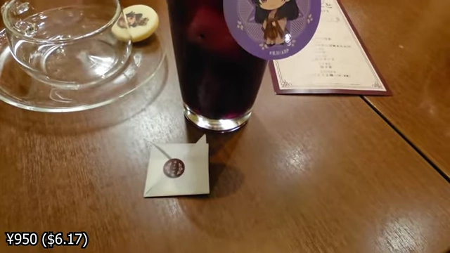 A blueberry soda with ice, a character tag, and a sachet of chamomile.