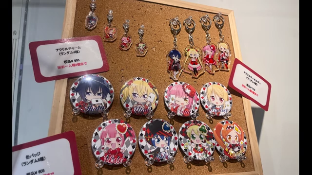 A display of Shugo Chara merchandise including stickers, keychains, and badges, all with similar chibi character art.