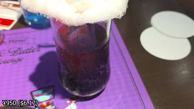 A cola drink with jelly at the bottom and a cloud of white cotton candy on top.