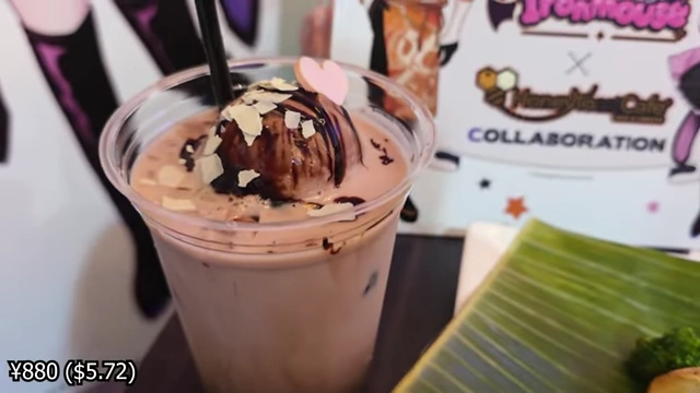 Strawberry milk topped with chocolate ice cream, chocolate sauce, and white chocolate shavings.
