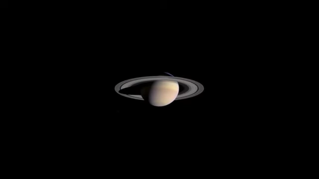 A view of Saturn, illustrating how a person's mass subtly affects celestial bodies and their eventual arrangements.