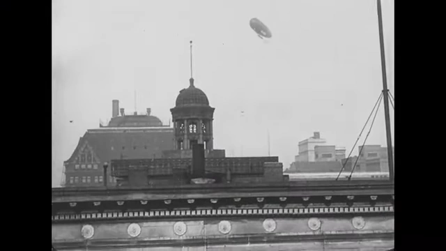 A view of Chicago filmed from a dirigible, illustrating how humans have expanded their presence and made the world their home.