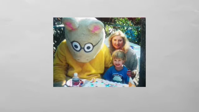 A young Evan as a child with his mother and a mascot, representing his early life.