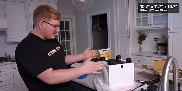A man next to the SVS 3000 Micro subwoofer, showing its dimensions of 10.9" x 11.7" x 10.7"