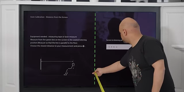 A screen showing the auto-calibration setup for measuring the distance from the screen to the listening position