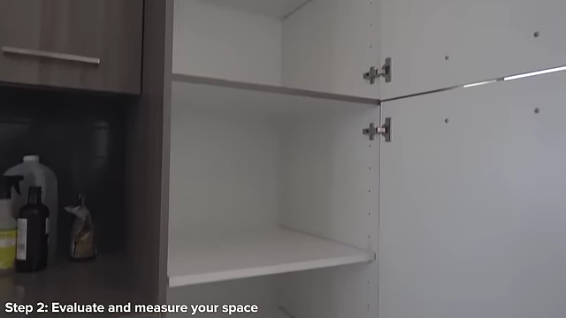 An empty pantry cabinet with adjustable shelves, ready for organization