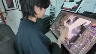 The artist working on digital art at her desk.