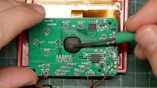 Close-up of the PCB showing the central epoxy blob and surrounding integrated circuits