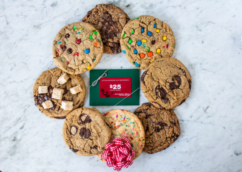 Lettuce Entertain You Holiday Gift Cards surrounded by holiday decorations and Summer House classic cookies for the Free $25 Holiday Bonus Gift Card Campaign