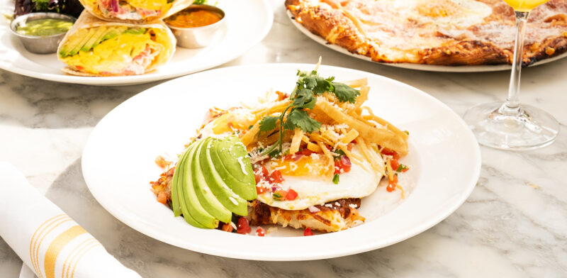 Summer House's Mexican Hashbrownns topped with two sunny-side-up eggs, avocado,ranchero sauce, oaxaca cheese, avocado, cilantro available on Mother's Day