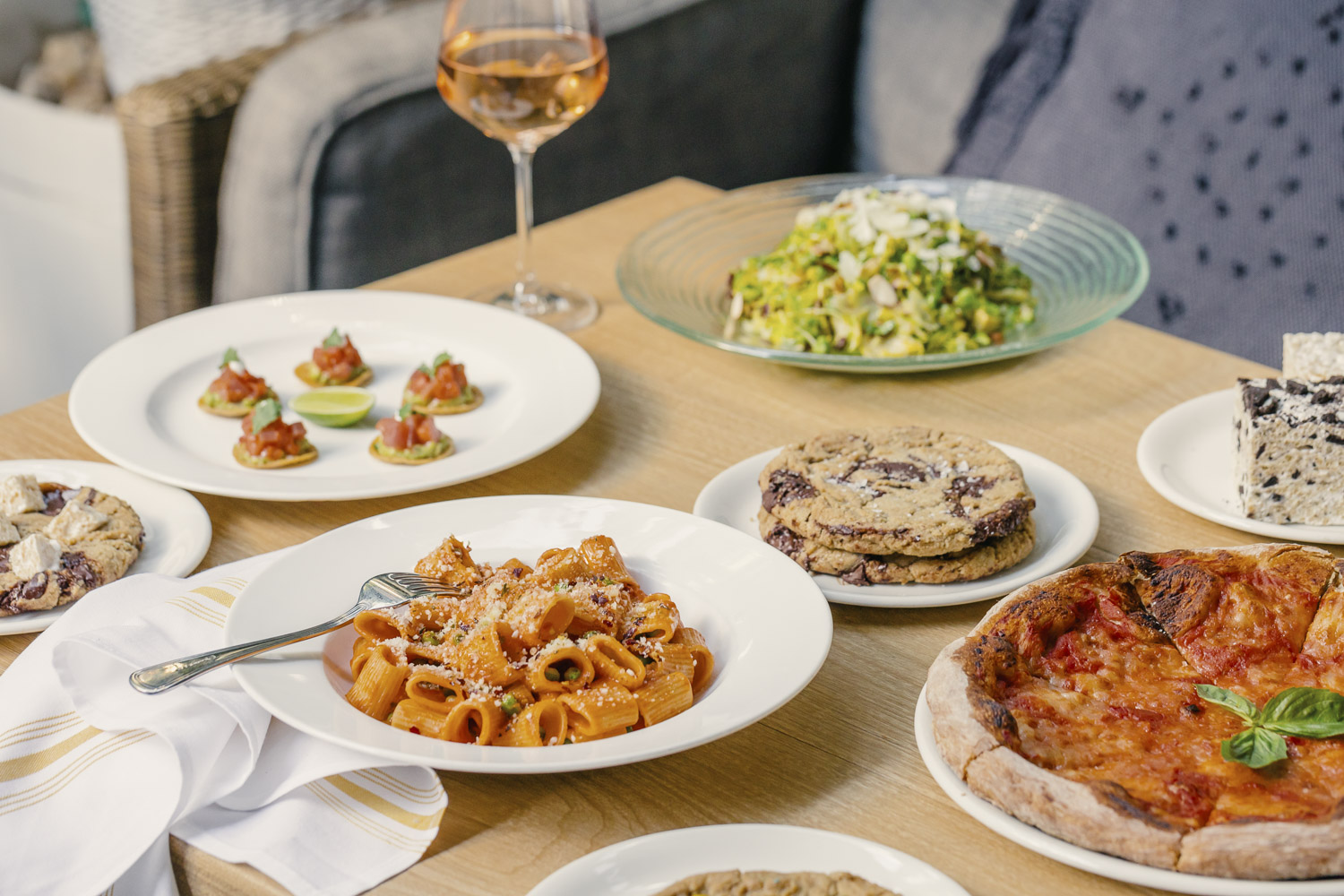 Spread of Summer House dishes including Rigatoni alla Vodka, Tuna Tostadas, Shaved Brussels Sprouts Salad, all available on Mother's Day