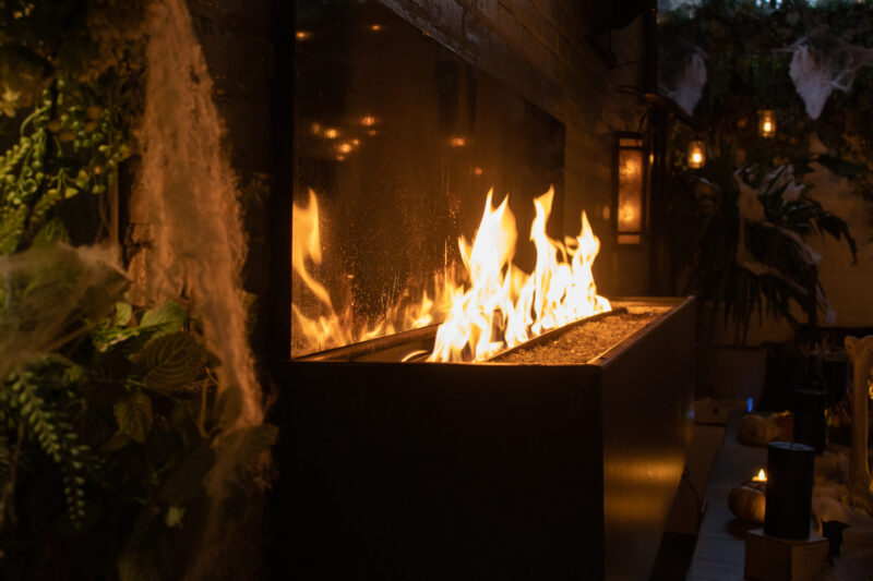 Summer House's fireplace used as a decorative photo for the Spooky Sweets & Spirits Cocktail Party