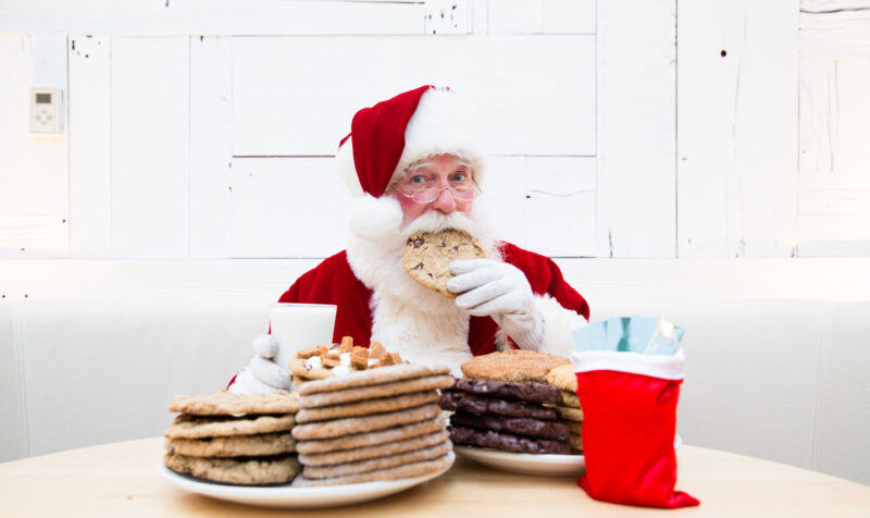 Santa at Summer House eating cookies from the bakery.