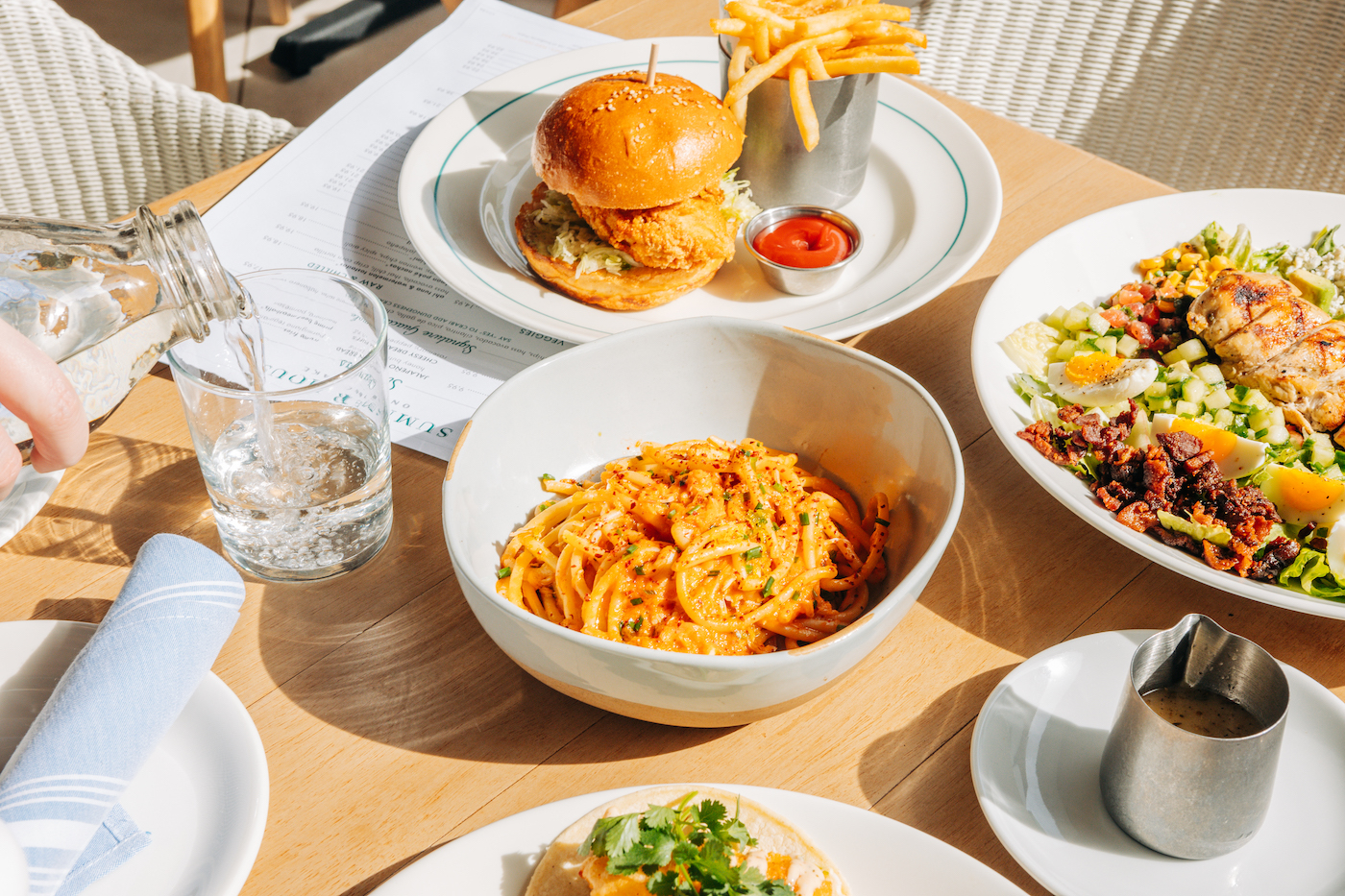 Group photo of Summer House dishes available on Mother's Day like the Spaghetti Pomodoro, Crispy Chicken Sandwich, Buena Vista Cobb Salad.